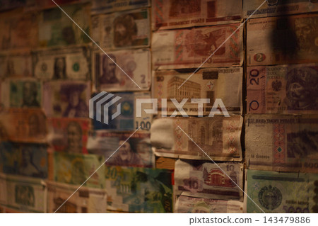 Collage of diverse international banknotes pinned to a wall. Collage of diverse international banknotes pinned to a wall. 143479886