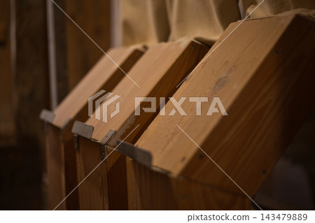 Close-up of traditional wooden grain chutes in a historic mill. Close-up of traditional wooden grain chutes in a historic mill. 143479889