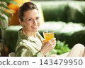 Radiant Woman with Fresh Morning Juice 143479950
