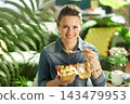 Woman Eating Fresh Fruit Salad at Home 143479953