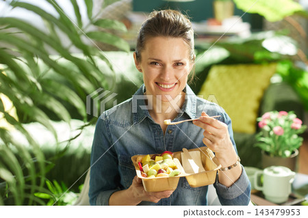 Woman Eating Fresh Fruit Salad at Home Woman Eating Fresh Fruit Salad at Home 143479953
