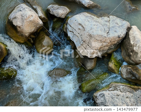 Small Cascading Waterfall Over Large Boulders in a Sunny Forest. 143479977