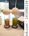 Iced coffee and matcha served in coconuts 143480134