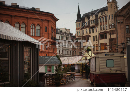 Panoramic view of a festive city square featuring historic eclectic architecture. Panoramic view of a festive city square featuring historic eclectic architecture. 143480317