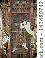 Christmas in Strasbourg, Alsace, France. Illuminated angels with trumpets above a historic street near Strasbourg Cathedral. 143480742