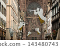 Christmas in Strasbourg, Alsace, France. Illuminated angels with trumpets above a historic street near Strasbourg Cathedral. 143480743