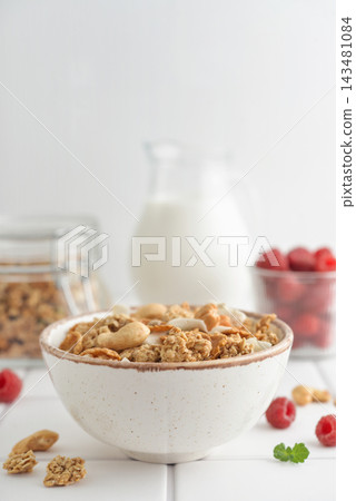 Muesli with fresh raspberries and nuts in a bowl, close-up Muesli with fresh raspberries and nuts in a bowl, close-up 143481084