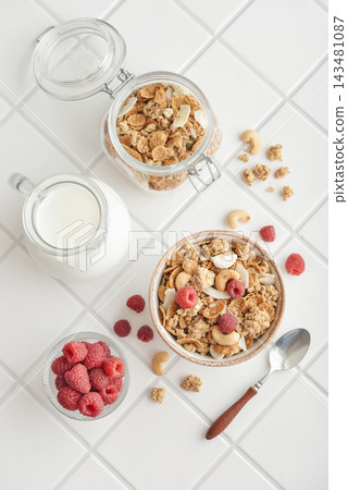 Breakfast ingredients arranged from above on a light tiled background Breakfast ingredients arranged from above on a light tiled background 143481087