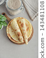Stack of lavash or chapati flatbreads on a wooden cutting board 143481108