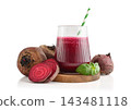 Beetroot juice in a glass with a striped paper straw, served with raw beetroot and fresh basil 143481118