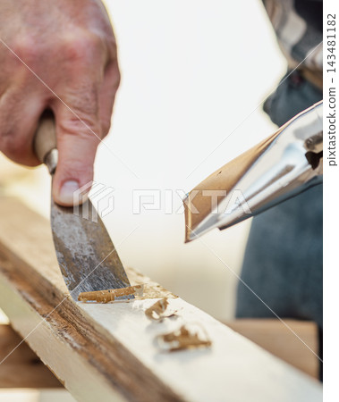 Carpenter at work, restoring an old wooden window. Carpentry. Carpenter at work, restoring an old wooden window. Carpentry. 143481182