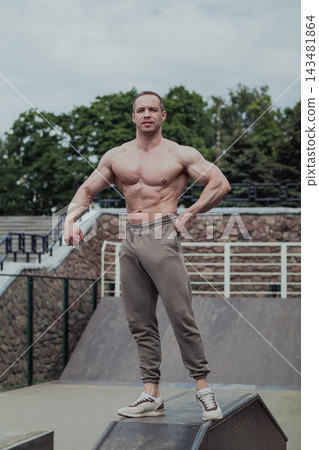 A CrossFit man poses for the camera on a sports A CrossFit man poses for the camera on a sports 143481864