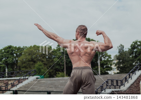 A CrossFit man poses for the camera on a sports A CrossFit man poses for the camera on a sports 143481868