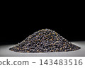 A studio photoshoot featuring a generous pile of roasted black sesame seeds, highlighting the texture of the ingredients. 143483516