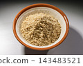 Close-up of white sesame powder in a mortar and pestle, a cooking ingredient. 143483521
