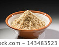 A close-up of white sesame powder in a mortar and pestle, a cooking ingredient. 143483523