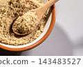 A scene of preparing finely ground sesame seeds using a wooden pestle in a mortar. 143483527