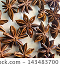 Rich, brown star anise pods photographed in macro detail, highlighting their star shapes, texture and glossy seeds 143483700