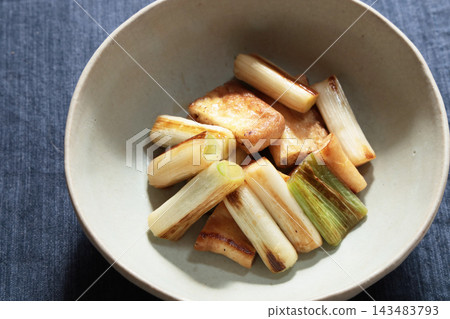 Stir-fried green onions and fried tofu in soy sauce Stir-fried green onions and fried tofu in soy sauce 143483793