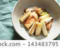 Stir-fried green onions and fried tofu in soy sauce 143483795