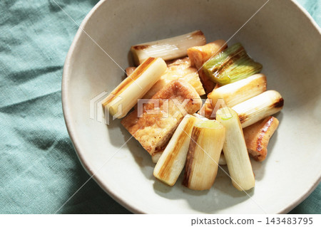 Stir-fried green onions and fried tofu in soy sauce Stir-fried green onions and fried tofu in soy sauce 143483795