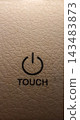 Macro view of touch sensitive power button on a textured surface. 143483873