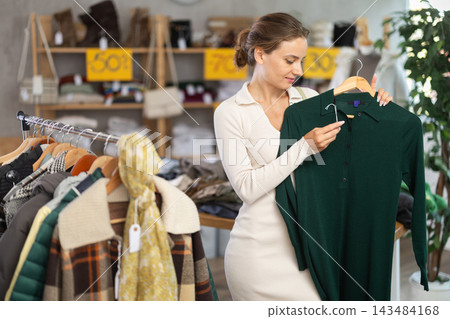 During November sales, woman choose and buy warm knitted dress During November sales, woman choose and buy warm knitted dress 143484168