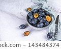 Fresh plums in a clay bowl. 143484374