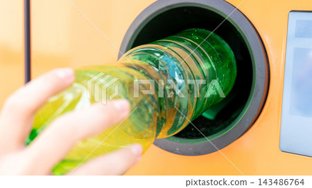 Reverse vending machine collecting empty beverage bottle. Reverse vending machine collecting empty beverage bottle. 143486764