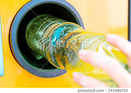 Used plastic bottle entering deposit collection machine. Used plastic bottle entering deposit collection machine. 143486783