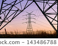 Transmission tower structure with electrical cables at dusk. 143486788