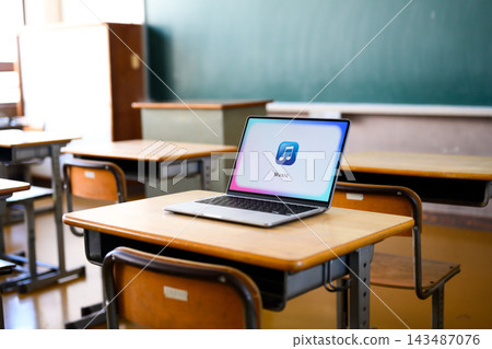 A music app is displayed on a laptop in the classroom. A music app is displayed on a laptop in the classroom. 143487076