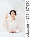 Smiling woman putting out ok sign 143487430