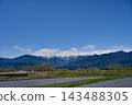 A spring rural landscape in Hakuba Village, Nagano Prefecture, with a view of the Northern Alps under a blue sky and still-snowy peaks. [Nagano Hakuba Landscape Photo] 143488305