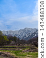 A vertical landscape photograph of Hakuba Village, Nagano Prefecture, showing the snow-capped Northern Alps and the spring countryside. [Nagano Hakuba Landscape Photograph] 143488308