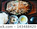 A set meal of stir-fried bean sprouts and meat served on a hot plate. 143488420