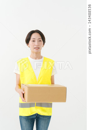 The delivery woman has a thoughtful expression on her face. The delivery woman has a thoughtful expression on her face. 143488536