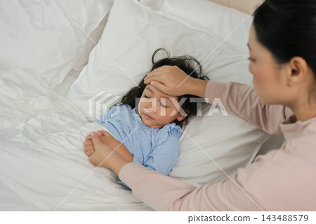 mother take care and checking forehead temperature of sick preschoool child girl while her sleeping in bed mother take care and checking forehead temperature of sick preschoool child girl while her sleeping in bed 143488579