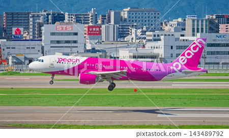 A Peach Aviation Airbus A320 passenger plane landing at Fukuoka Airport. A Peach Aviation Airbus A320 passenger plane landing at Fukuoka Airport. 143489792