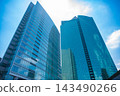Clouds reflected in office buildings in a business district [City image] 143490266