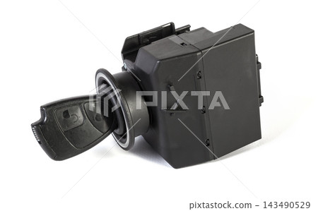 Electronic ignition lock with a key and a button made of black plastic on a white isolated background in a photography studio, a spare part for car repair or for sale in junk yard Electronic ignition lock with a key and a button made of black plastic on a white isolated background in a photography studio, a spare part for car repair or for sale in junk yard 143490529