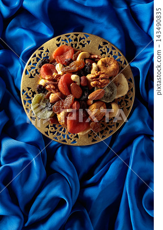 Assortment of dried tropical fruits, nuts and raisins. Assortment of dried tropical fruits, nuts and raisins. 143490835