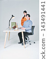 Men and women working at desks 143491441