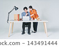 Men and women working at desks 143491444