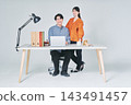 Men and women working at desks 143491457