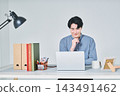 A man working at a desk 143491462