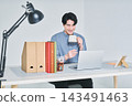 A man working at a desk 143491463