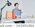 A man working at a desk 143491464