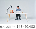 A man working at a desk 143491482