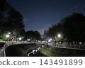 A city river flowing through a park at night 143491899